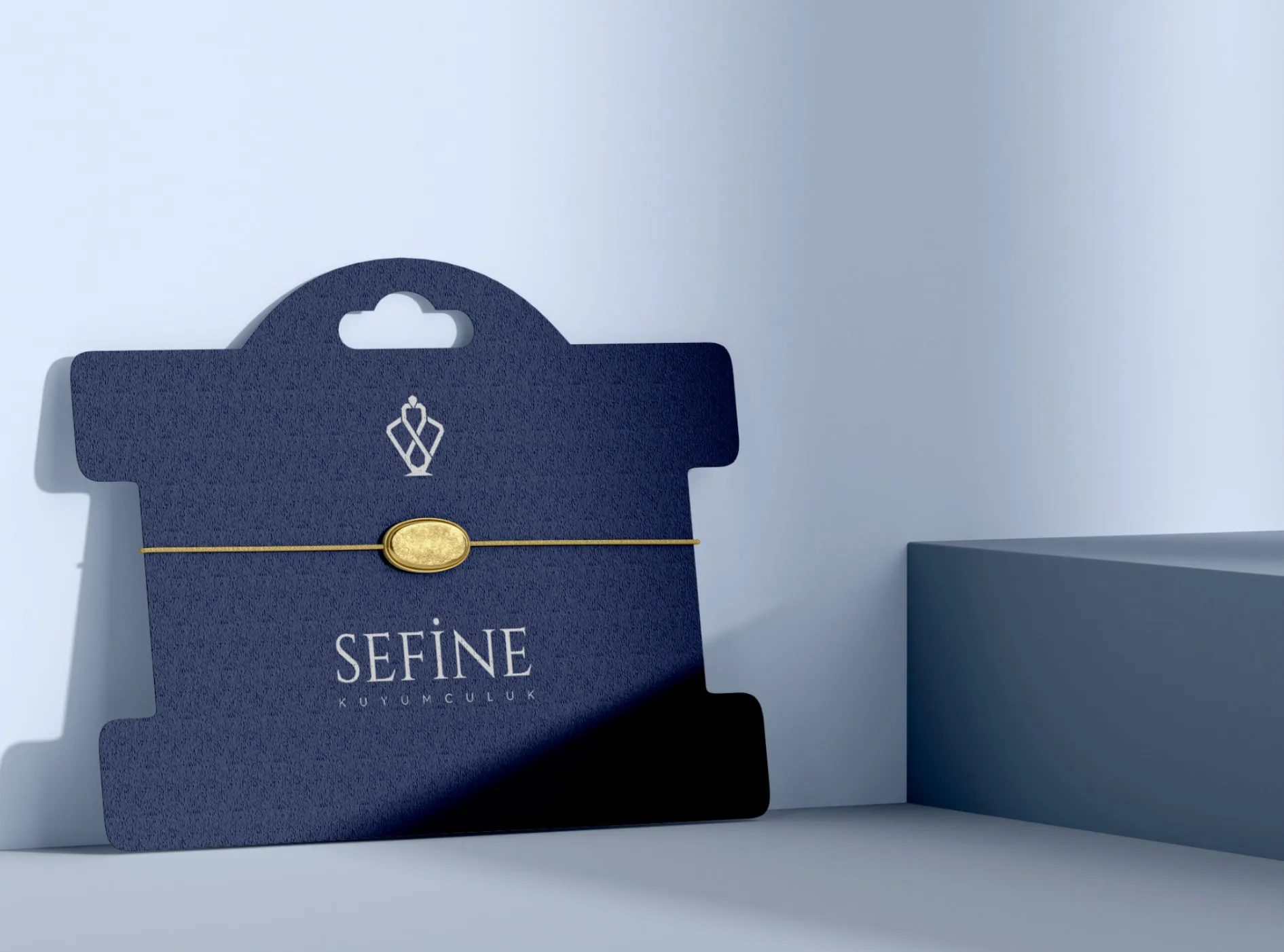 Sefine bracelet card: gold bracelet on a navy hang card
